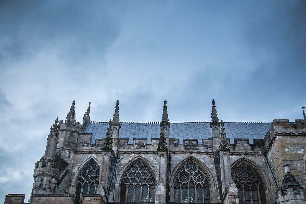 building grey and blue painted roof castle under blue sky spire