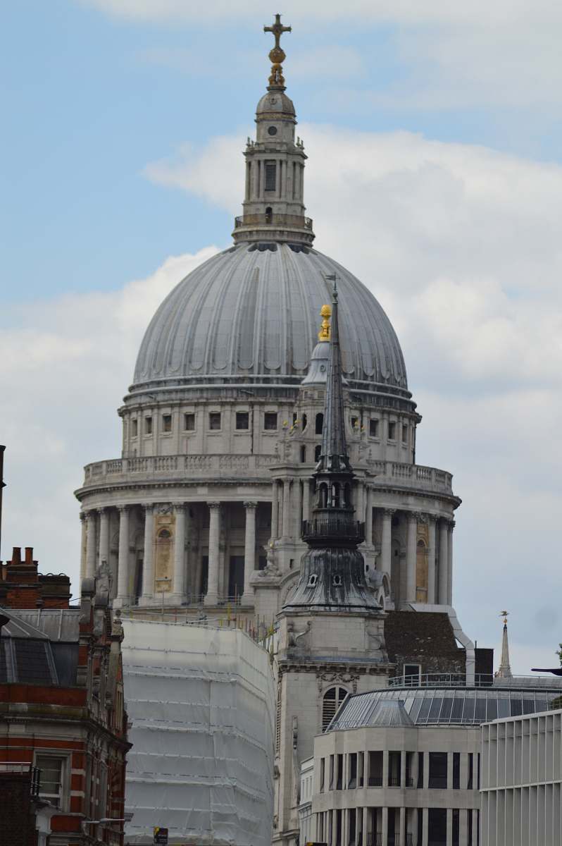 building grey cathedral under blue and white cloudy sky dome