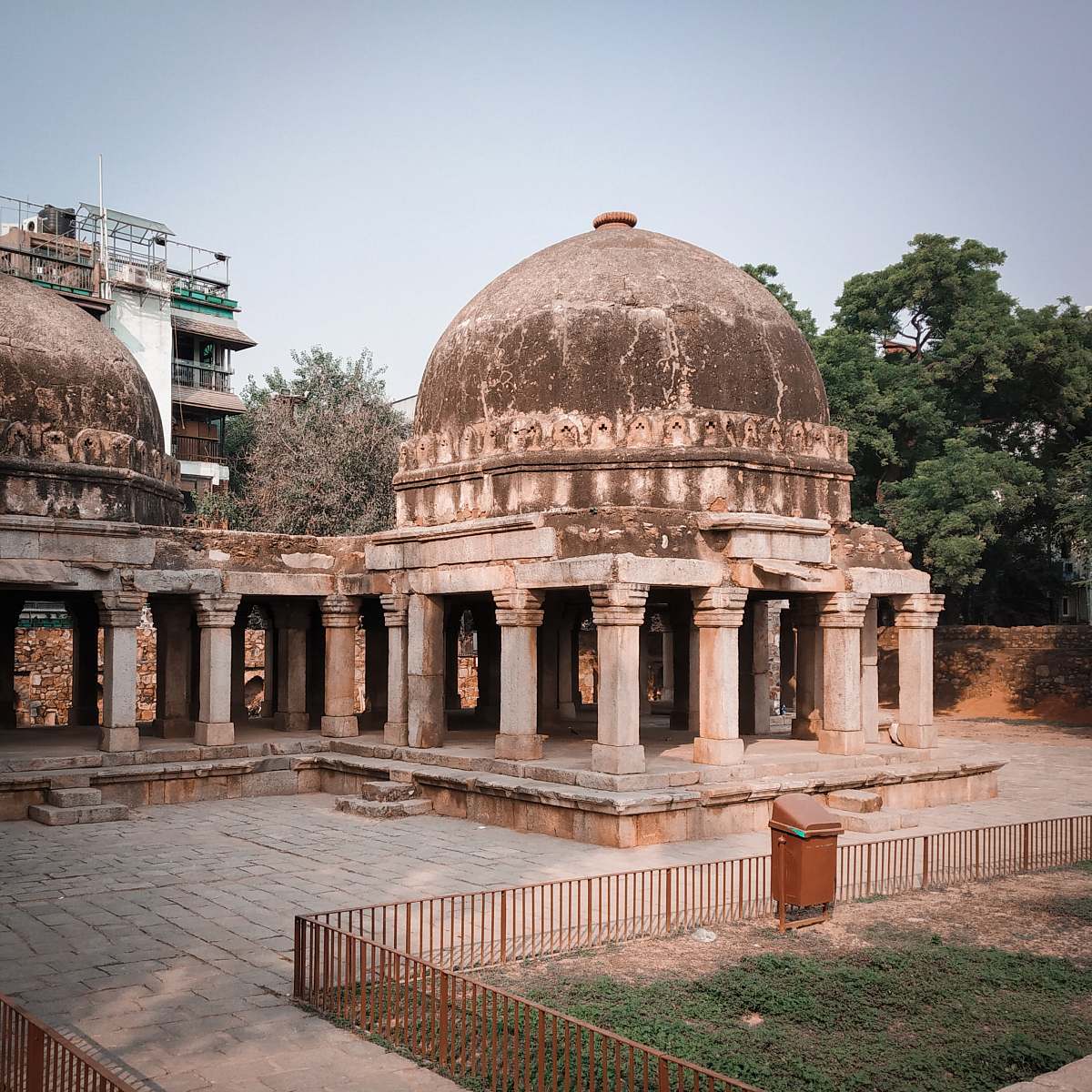 building grey concrete domed building near green leafed tree dome