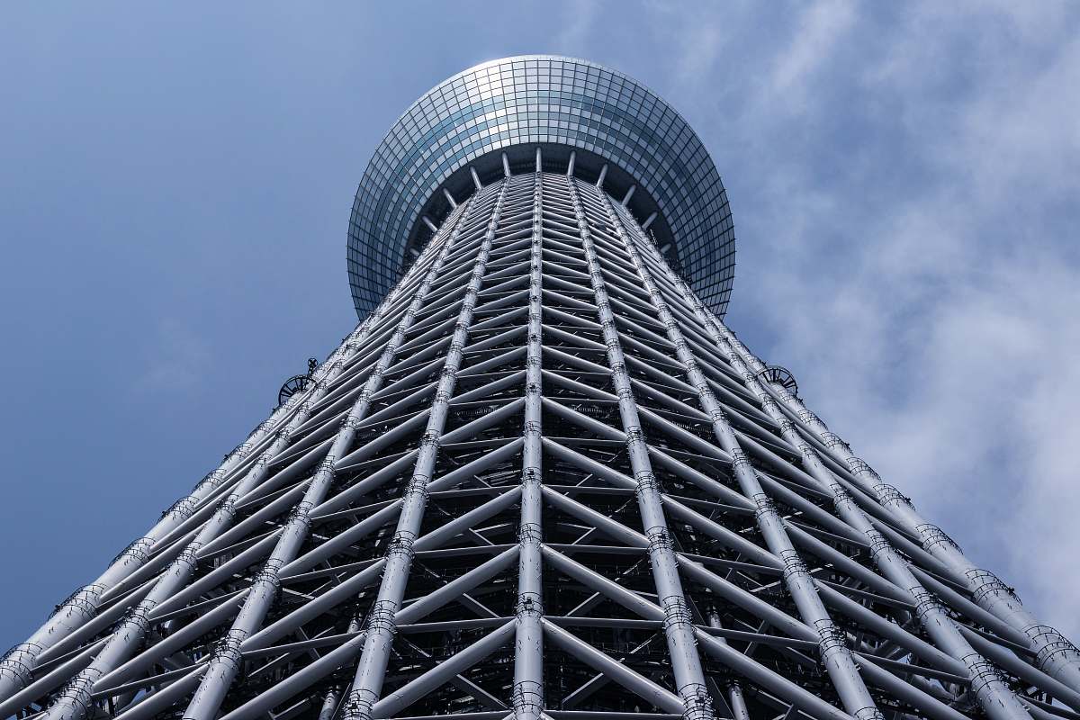 building grey tower with round top under grey cloudy sky tower