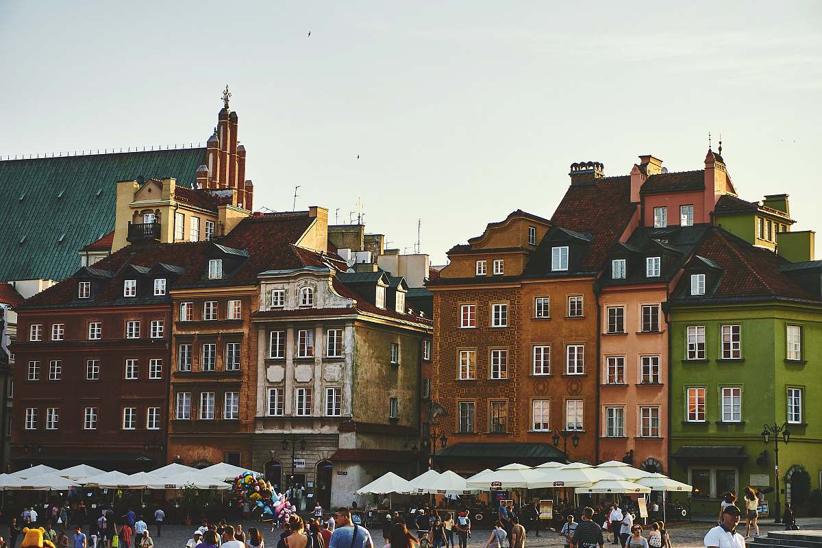 poland group of people on street near the brown concrete building city