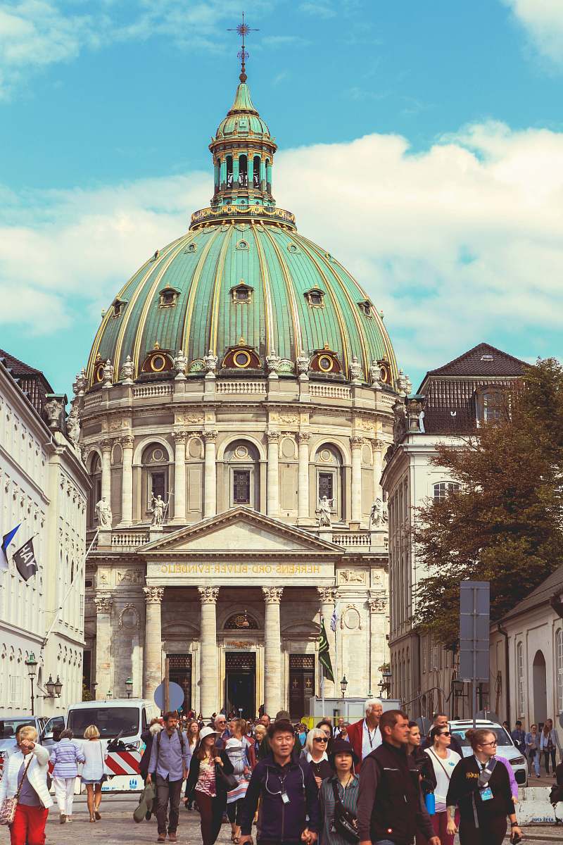 building group of people walking in front of concrete building dome