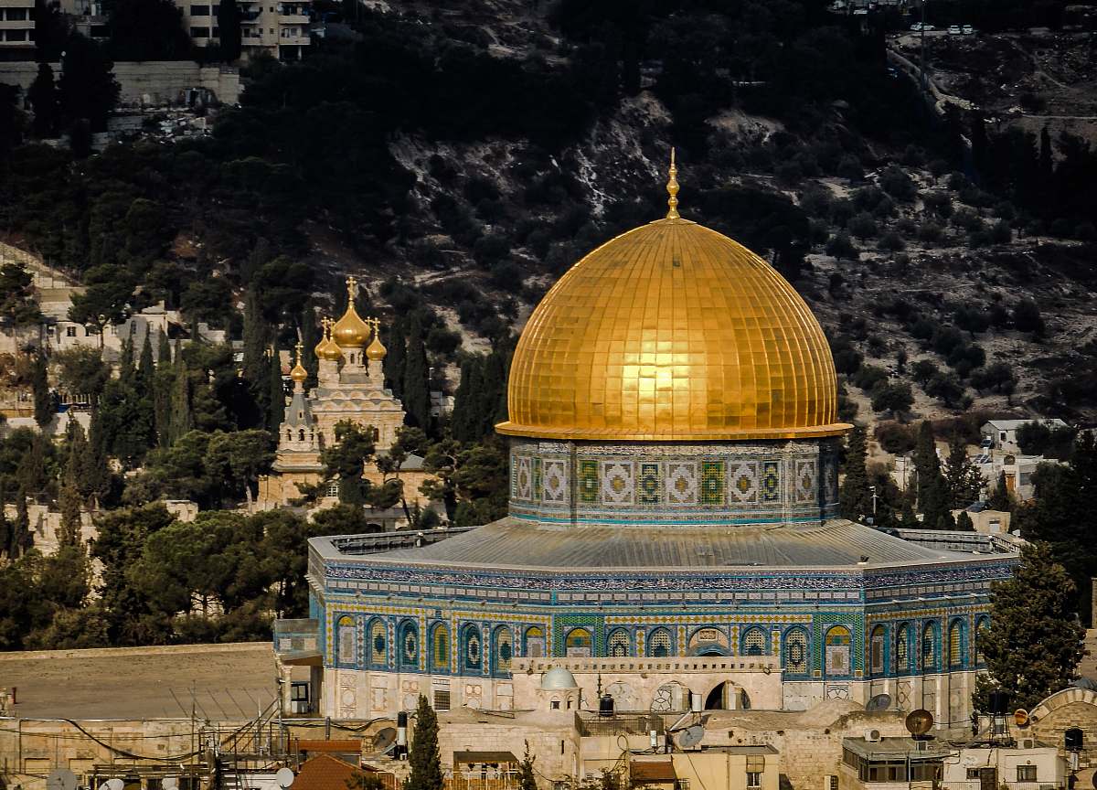 building in distant photo of gold and blue temple dome