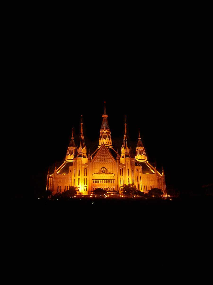 building lighted castle at night spire