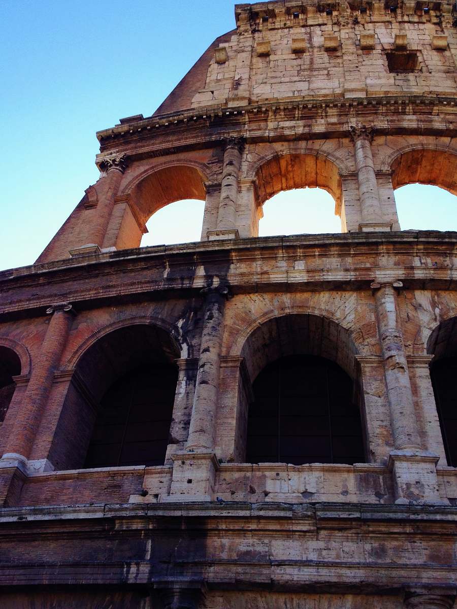 building low angle photo of brown coloseum arch