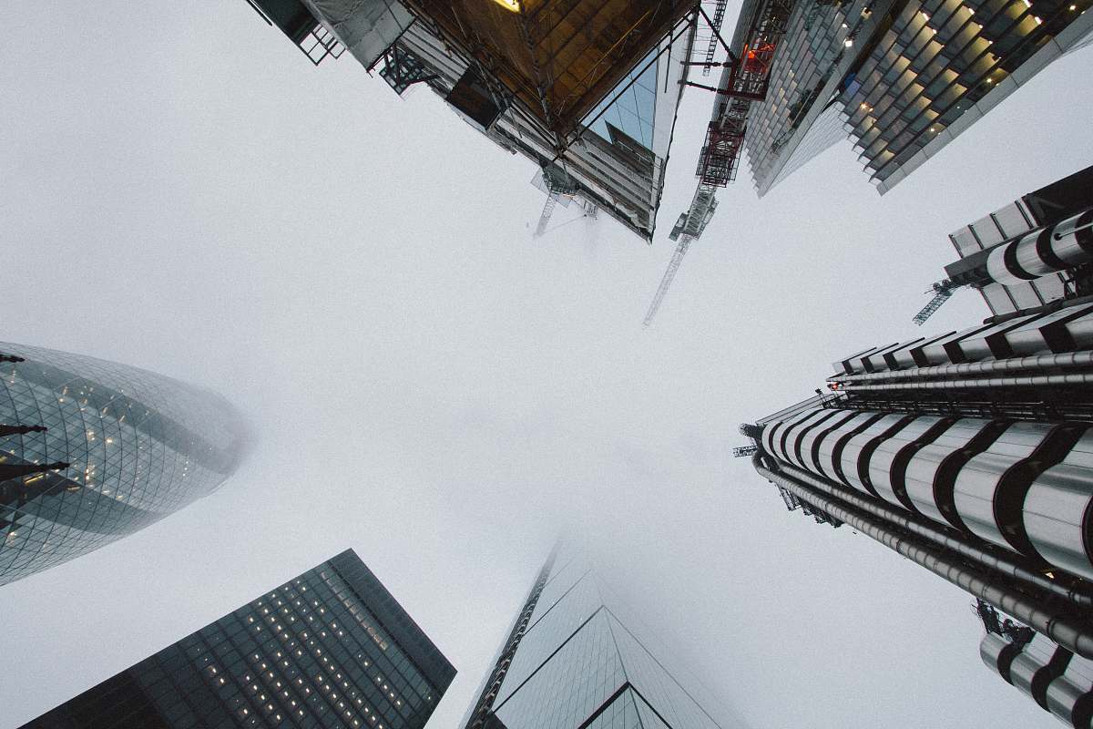 building low angle photo of high rise building covered with fog city