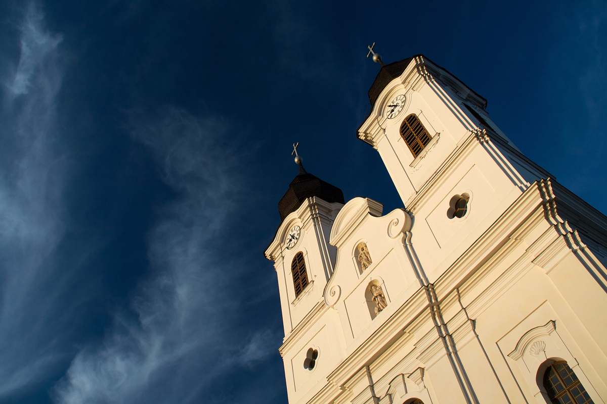 building low angle photo of white cathedral under blue sky tower