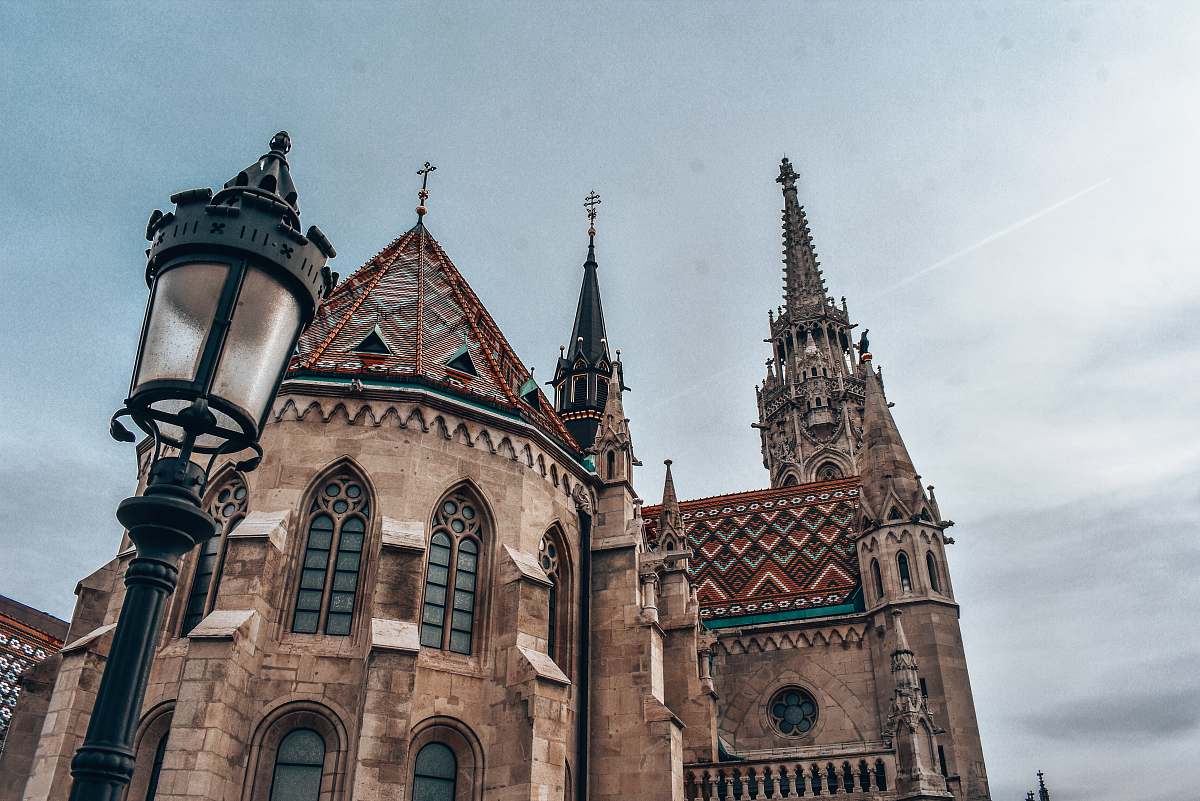 building low-angle photography of brown castle during daytime spire