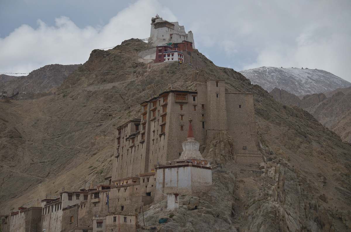 building low-angle photography of buildings on rocky mountain during daytime housing