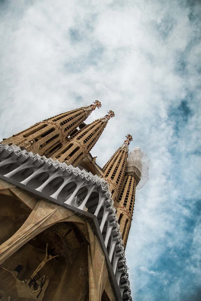 tower low-angle photography of concrete cathedral under cloudy sky steeple
