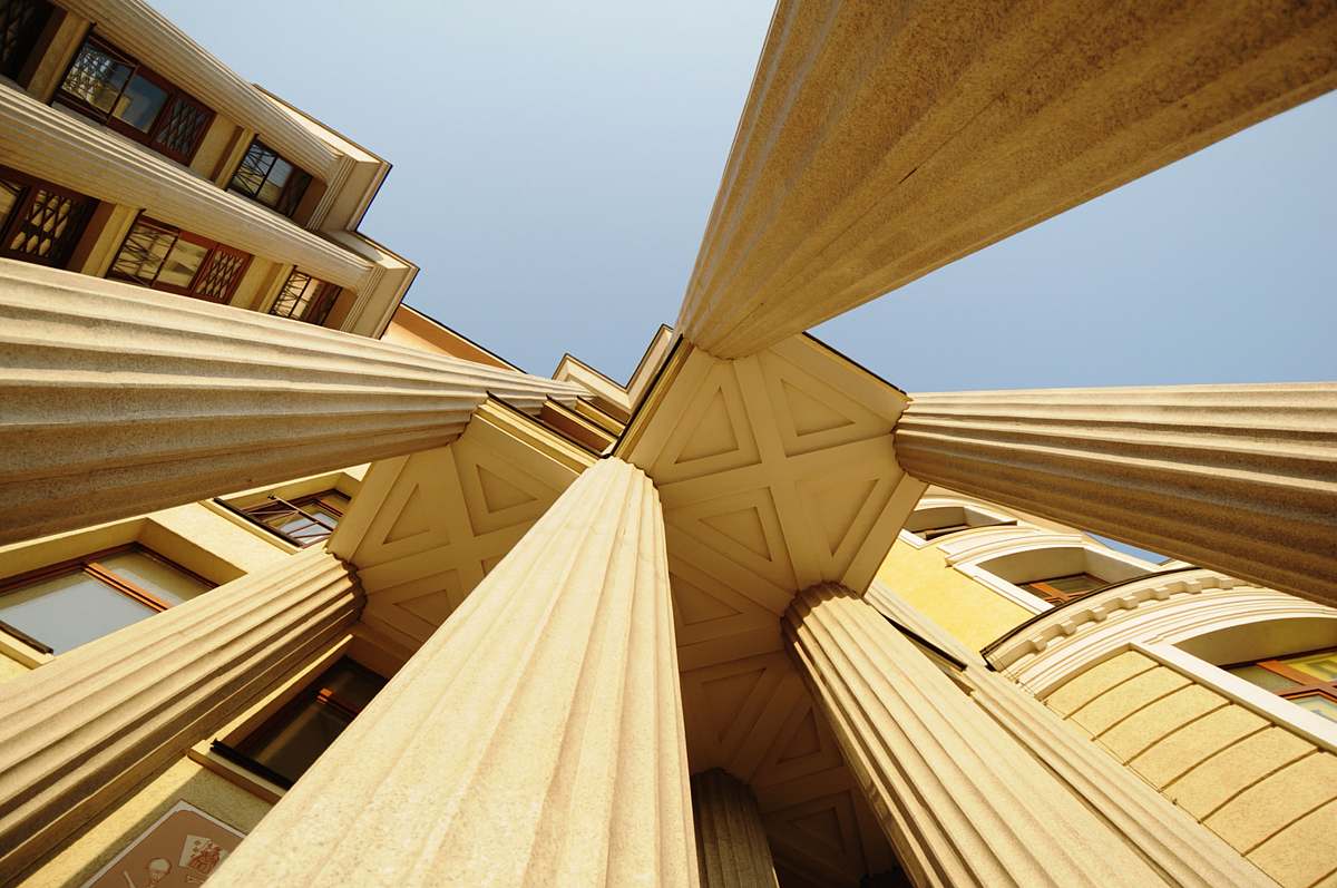 building low-angle photography of concrete pillars of a building wood