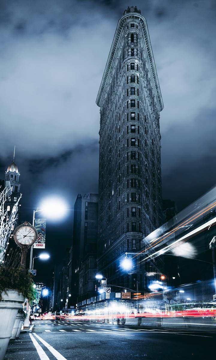 building low angle photography of high-rise building at night-time steeple