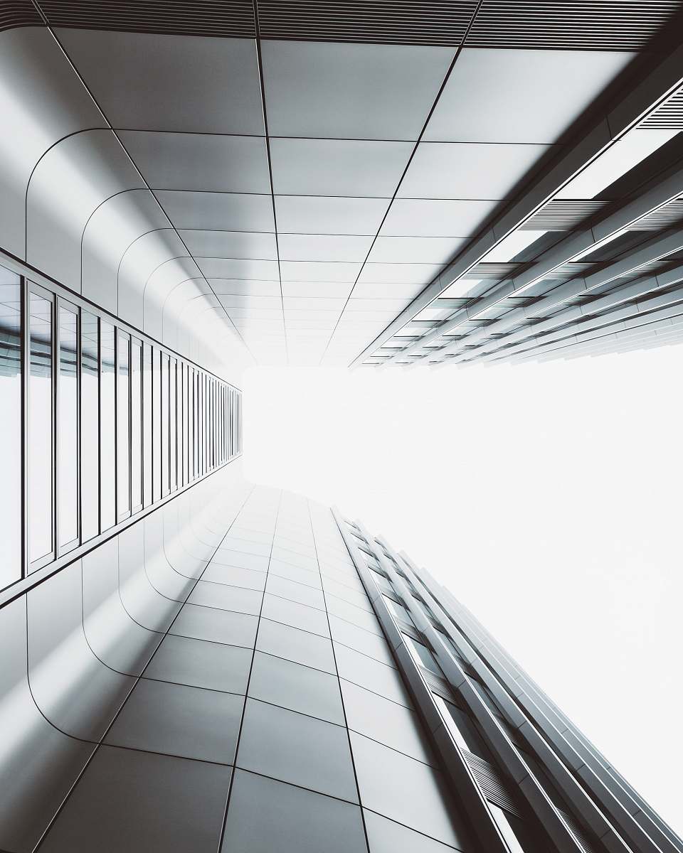 city low angle photography of high-rise building white
