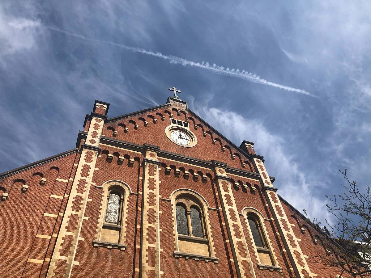 building low-angle photography of red concrete cathedral tower