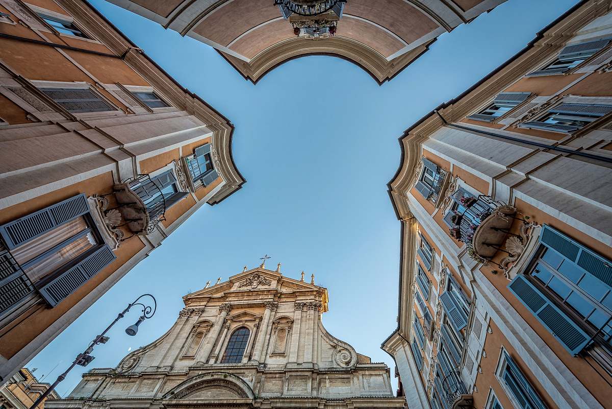 building low-angle photography of white and orange buildings under blue sky blue