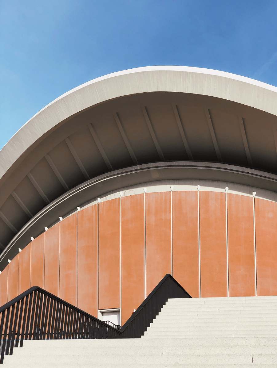 building orange and white concrete building under blue sky planetarium