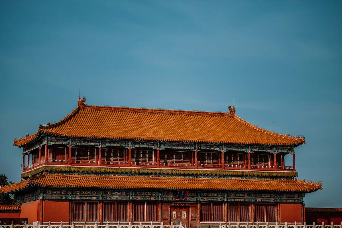 building orange temple under blue sky during daytime housing