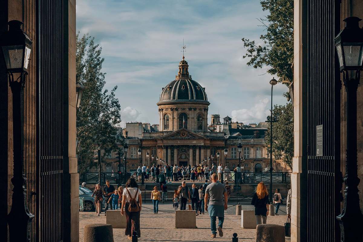 building people on park in front of domed building human
