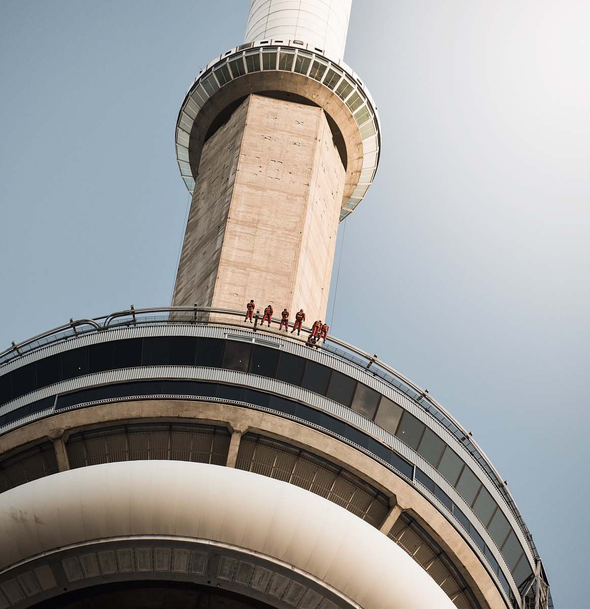 building people on tower railing during day tower