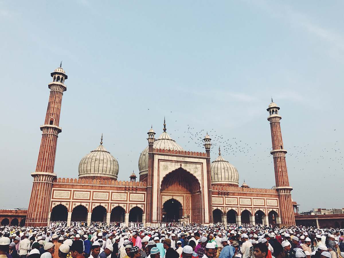 building people outside mosque dome