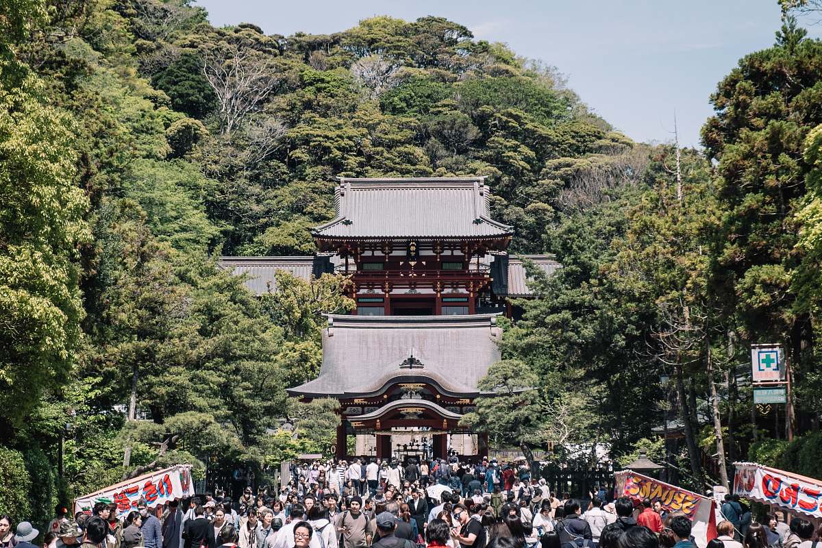 building people outside temple surrounded by trees shrine