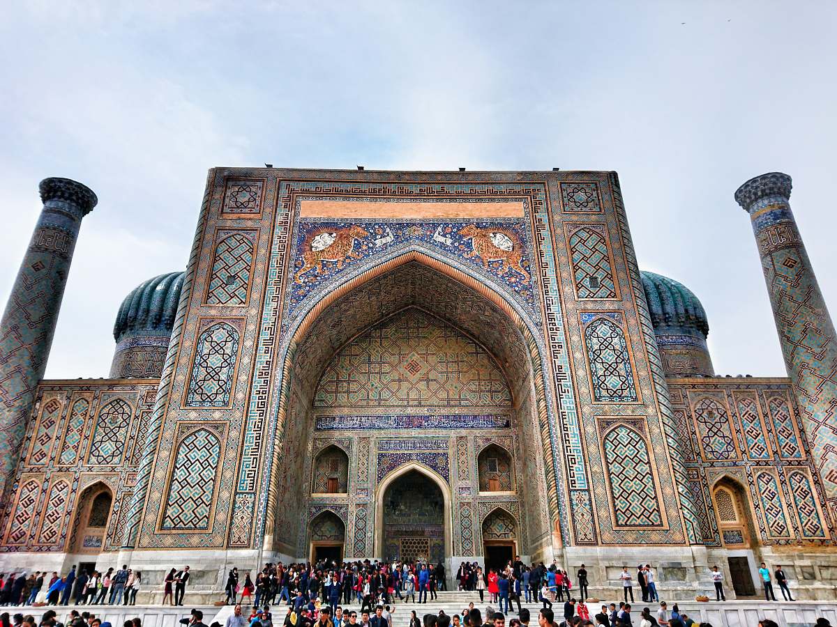 building people standing outside mosque during daytime dome