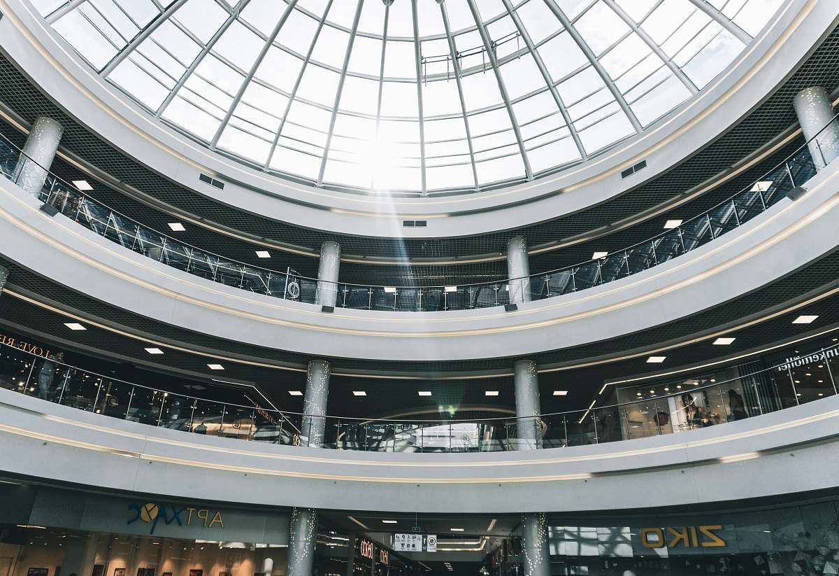 building people walking inside building with dome roof window