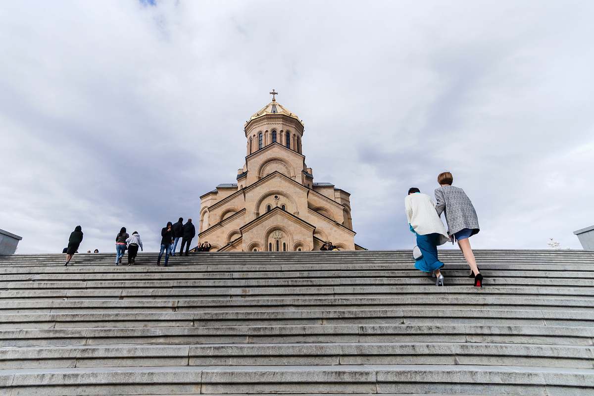 banister people walking near church handrail