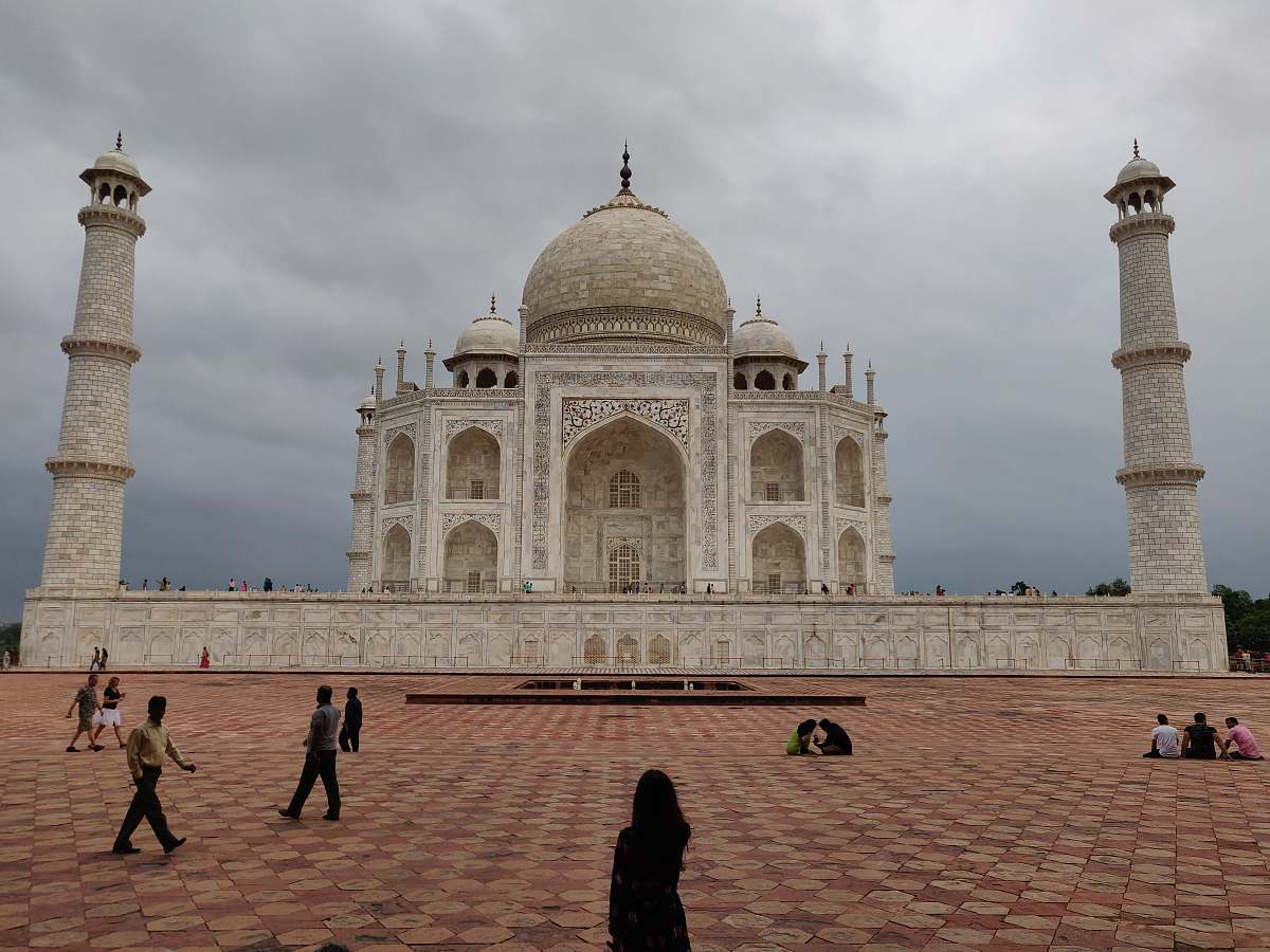 building people walking near Taj Mahal dome