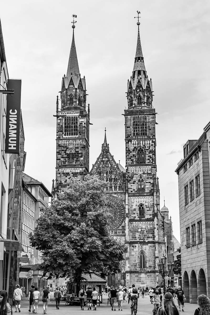 building people walking on streets black-and-white