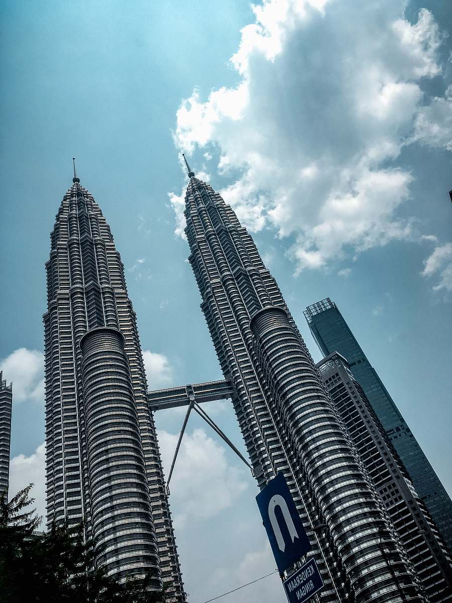 building Petronas Tower under blue and white skies spire