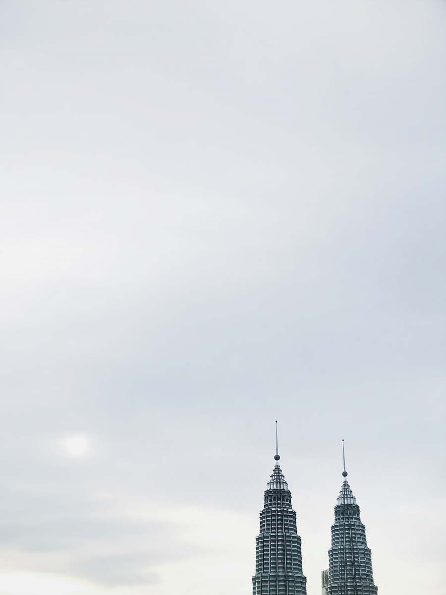 building Petronas Towers during daytime spire