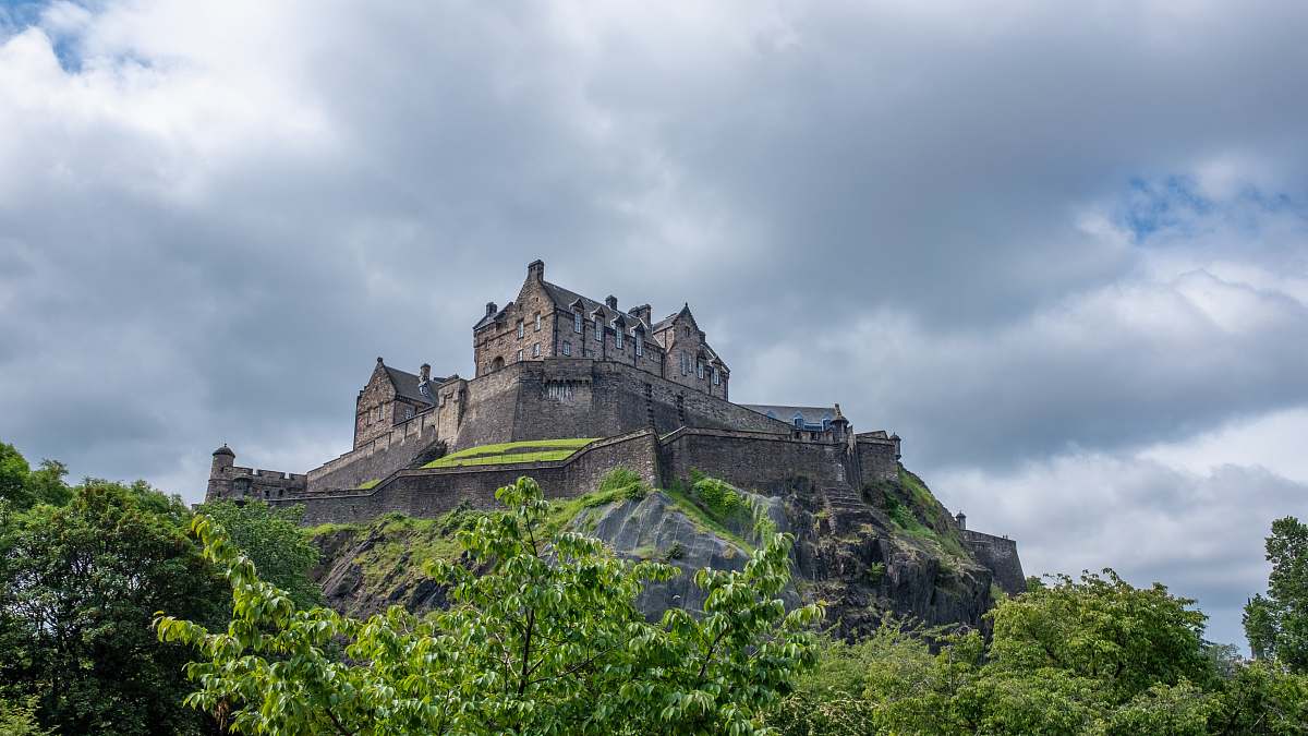 building photography of gray building on top of mountain during daytime castle
