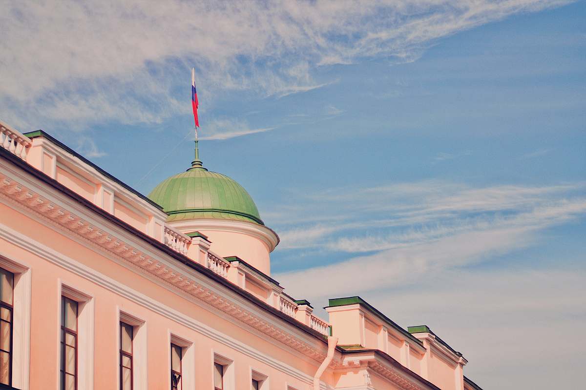 building pink and green dome building under blue and white skies during daytime dome