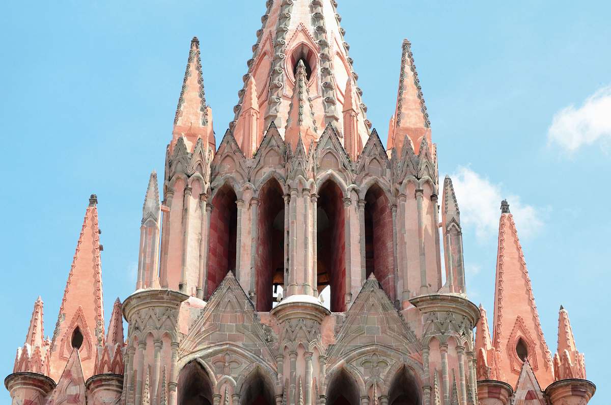 tower pink castle during daytime steeple