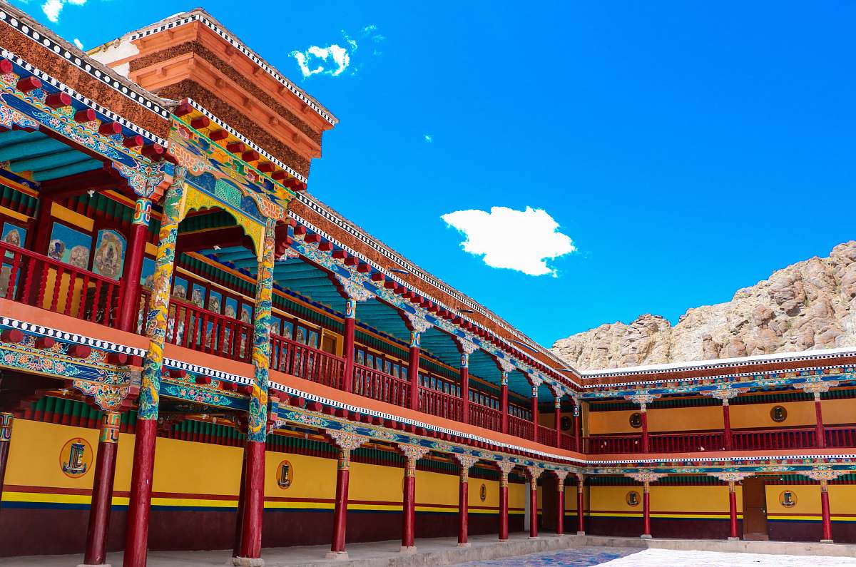 building red and yellow painted temple under blue and white sky monastery