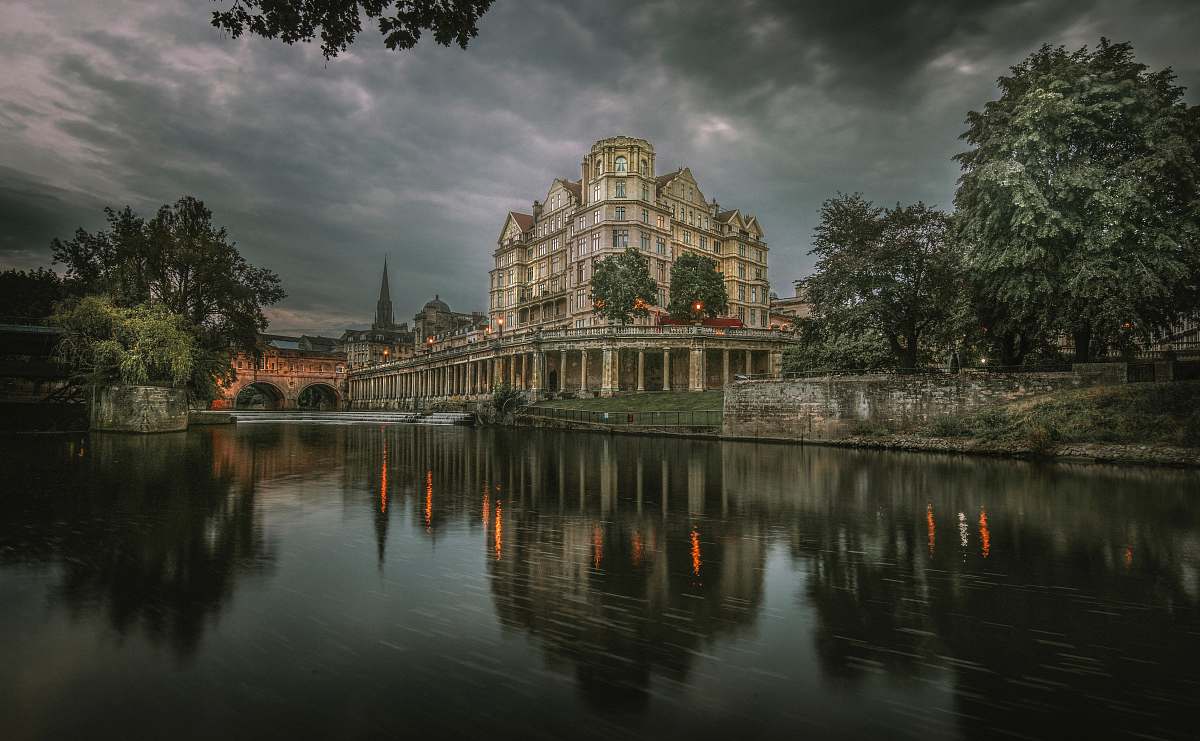 building reflection of gray building on body of water during daytime castle