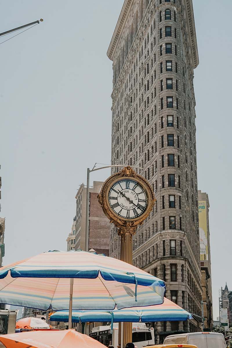 building round analog clock near Flatiron building at New York during daytime tower