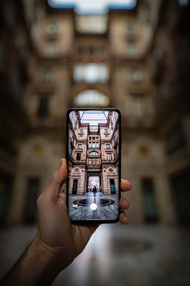 person shallow focus photography unknown person holding black smartphone human