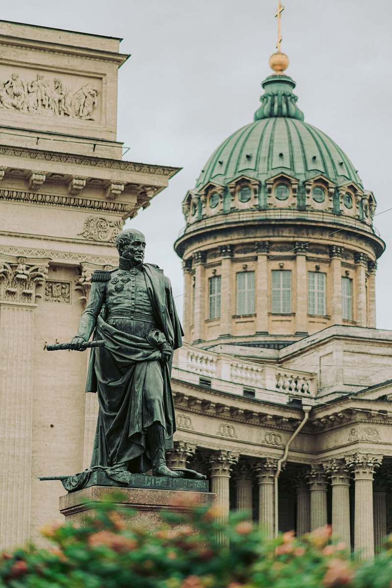 building statue of a man outside a dome cathedral dome