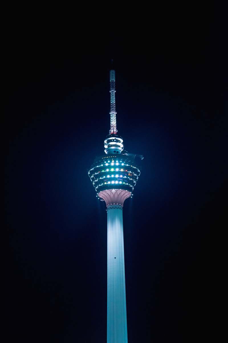 building teal and red tower during night time tower