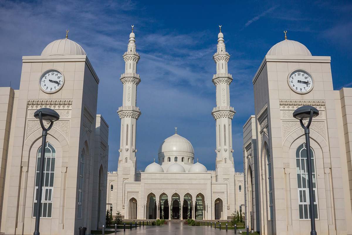 building temple with two clock towers during day dome