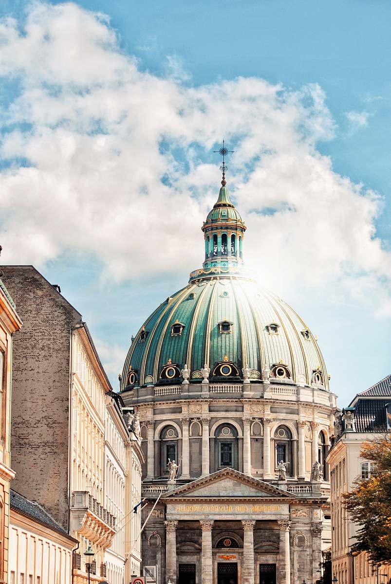 building white and blue church across white clouds dome