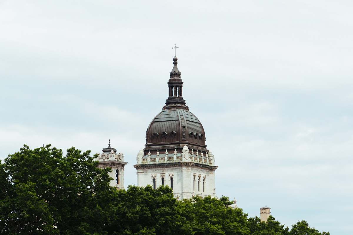 building white and brown church near trees dome