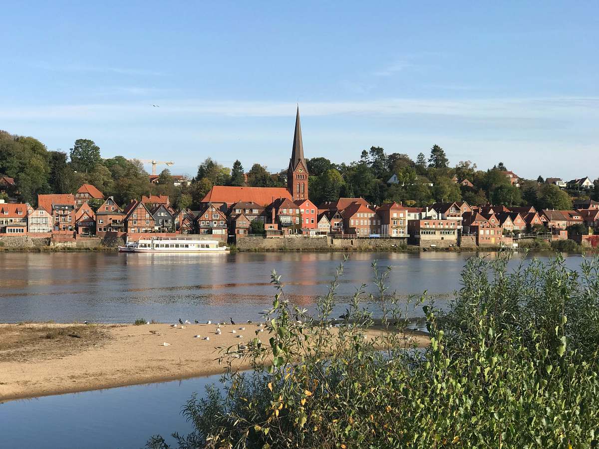 building white and brown houses near body of water spire
