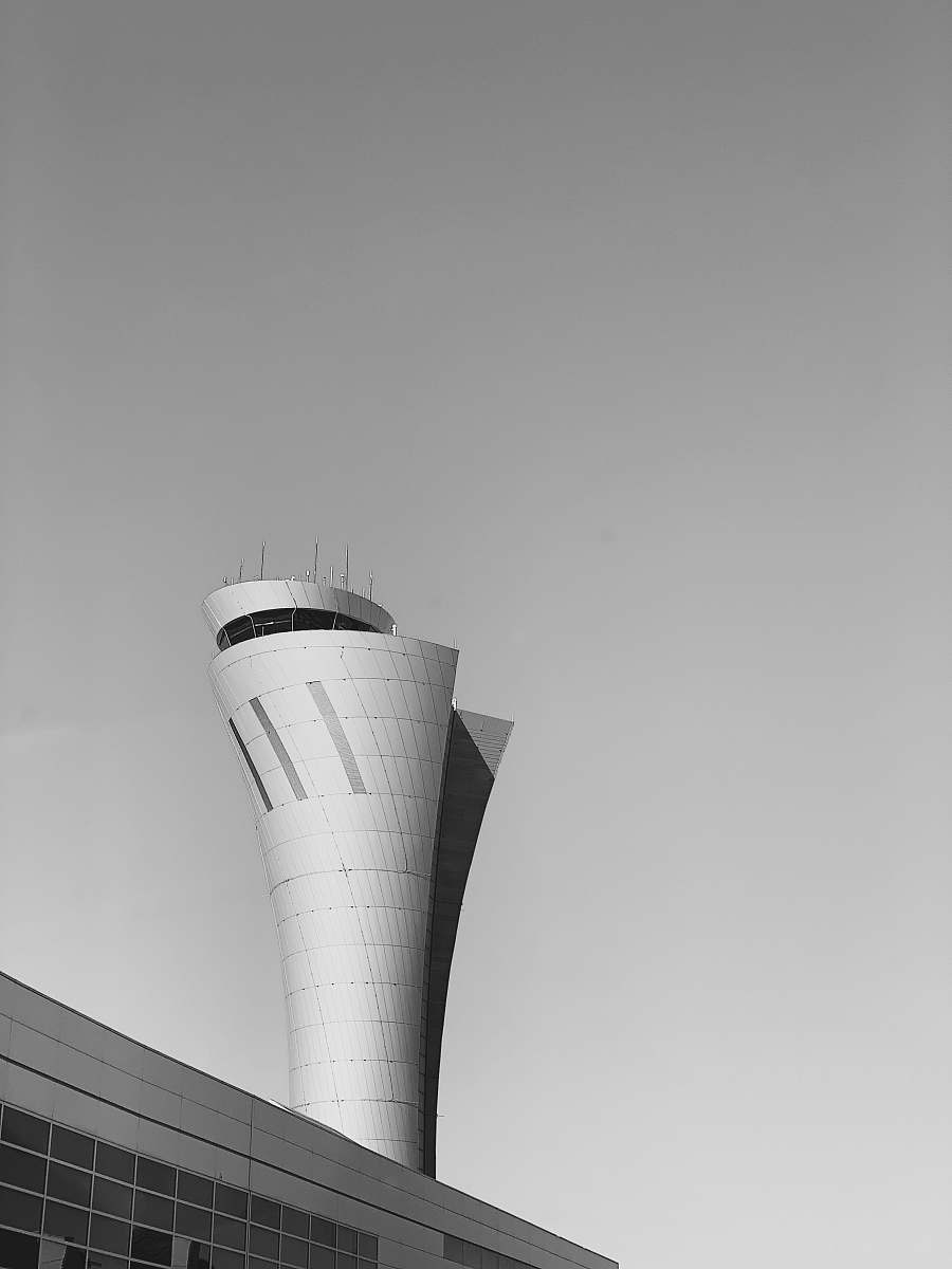 building white and gray concrete building under white sky during daytime black-and-white