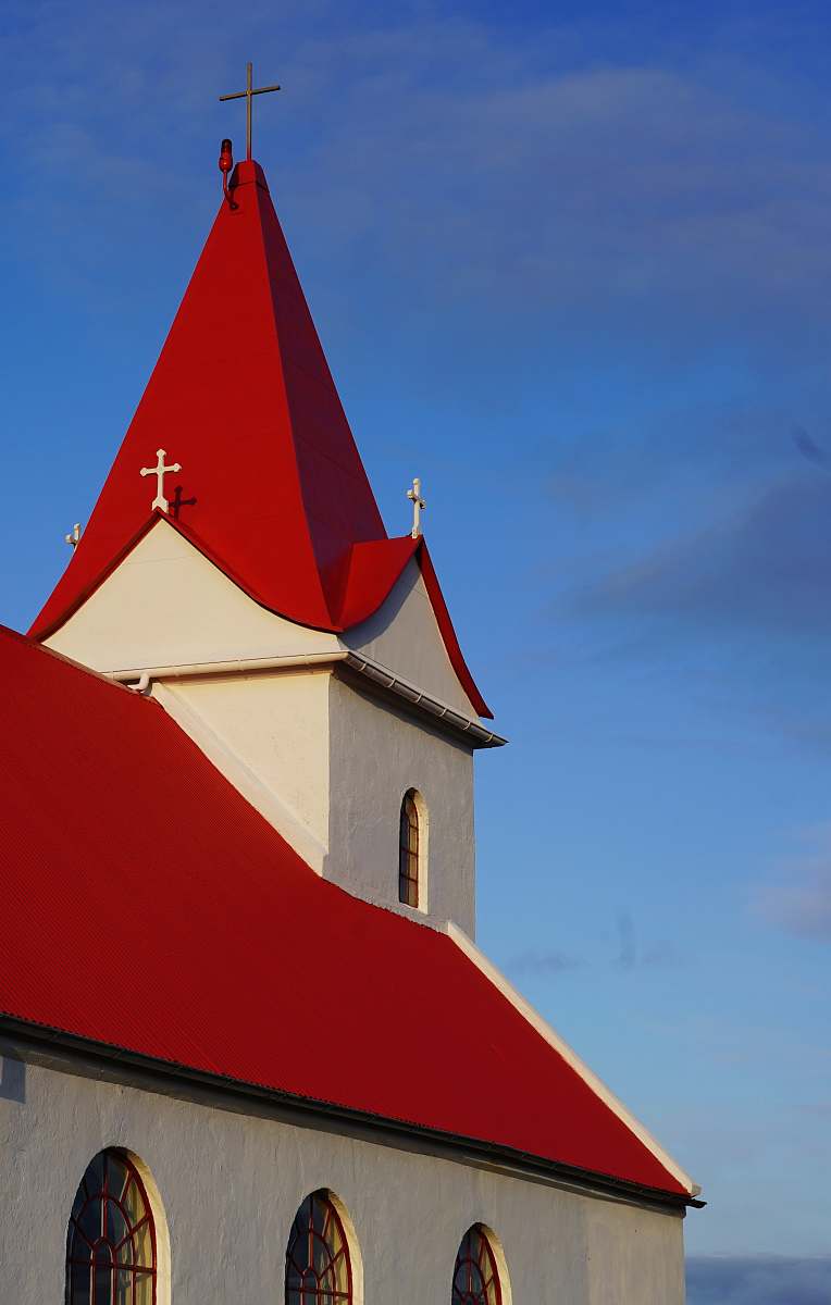 building white and red chapel at daytime spire