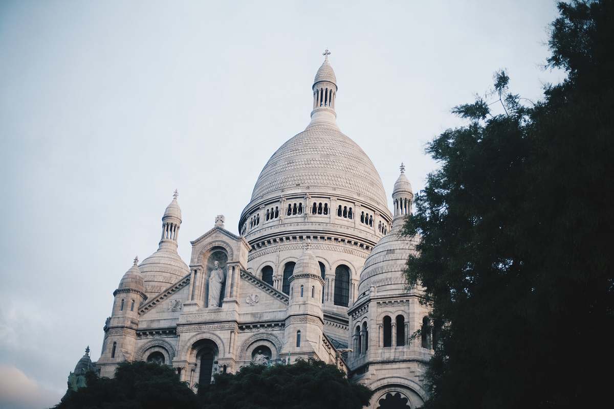 building white cathedral near tree at daytime dome