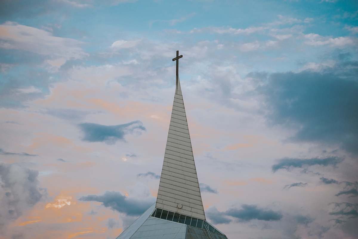 building white church under blue sky during daytime spire
