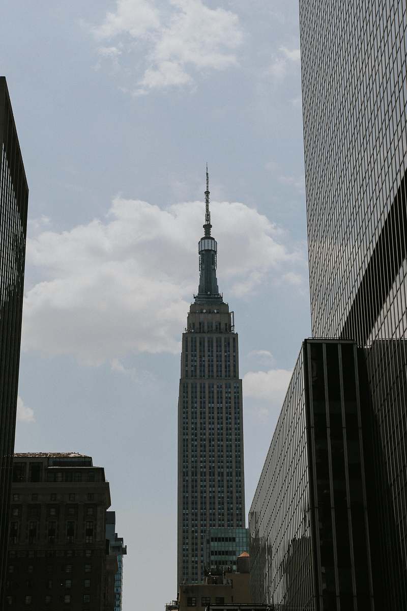 building white clouds above tower spire